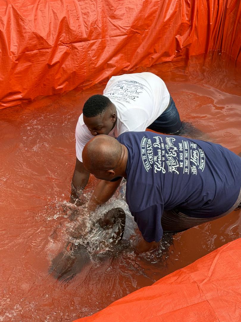 A new believer being baptised by immersion