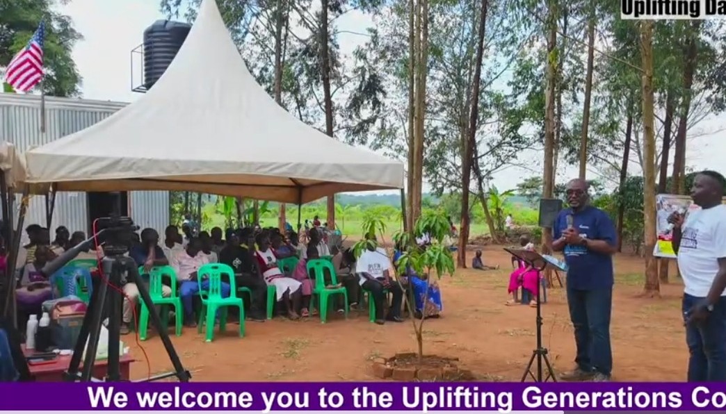 Congregation seated under a tent in Tema Village as Pastor Gladstone Johnson speaks