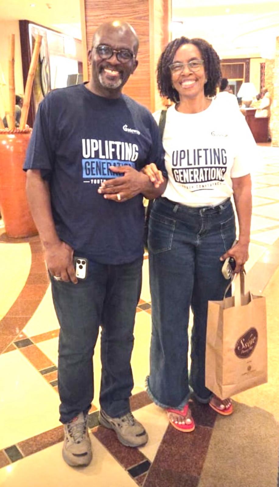 Pastors Gladstone and Cheryl Johnson wearing Uplifting Generations Youth Conference T-shirts