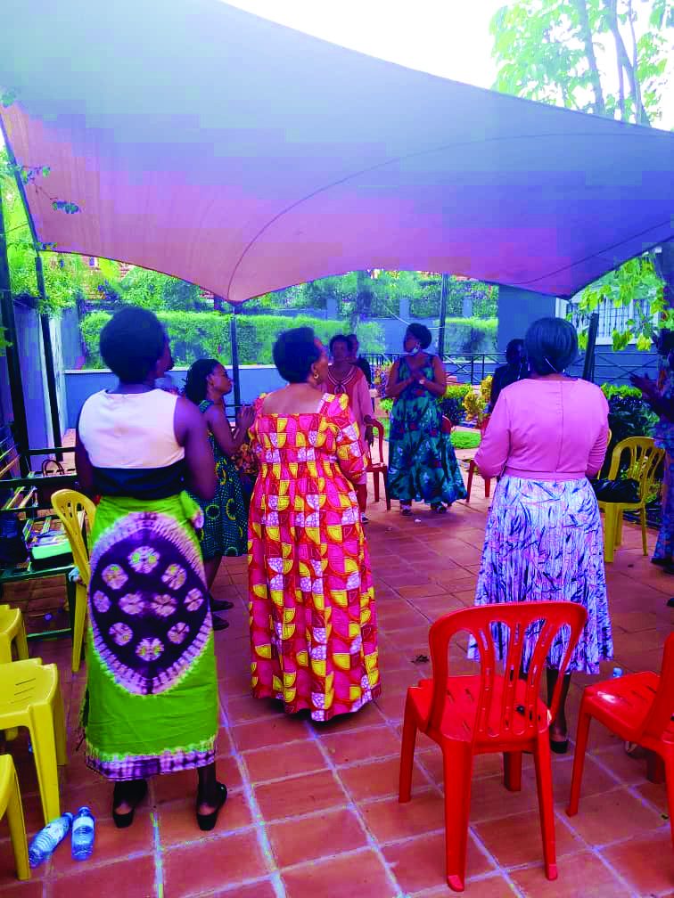 Women dancing in celebration under the tent