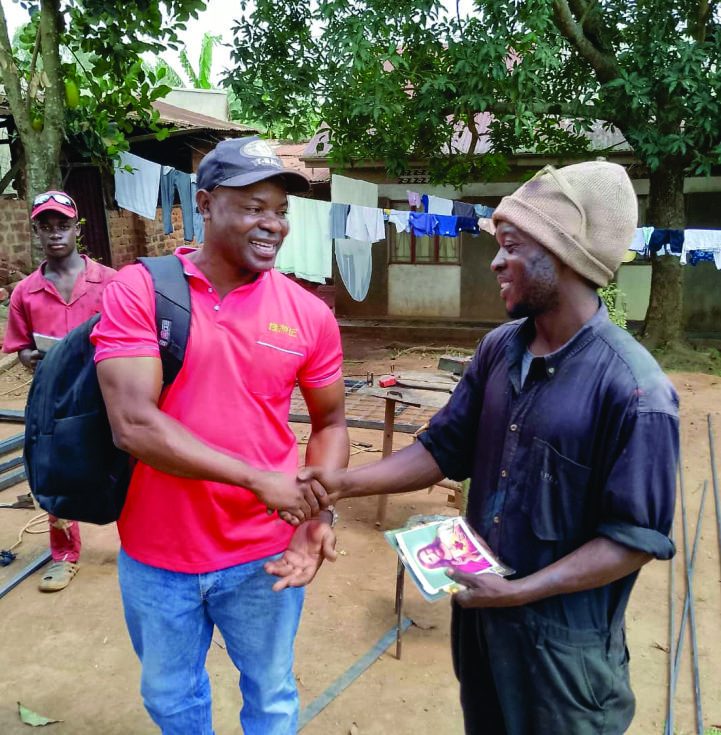 Jonathan Ssempijja with a youth